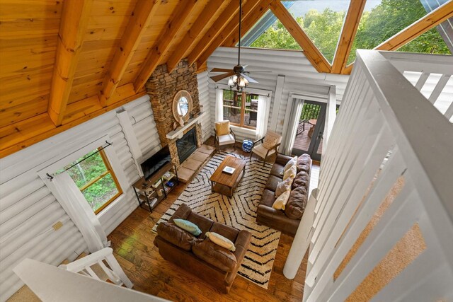 945 Scenic Trl, Gatlinburg, TN 37738 - living room featuring wood-type flooring, plenty of natural light, a stone fireplace, high vaulted ceiling, and ceiling fan