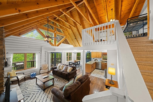 945 Scenic Trl, Gatlinburg, TN 37738 - living area with high vaulted ceiling, light wood finished floors, a wood ceiling with exposed beams, and stairs