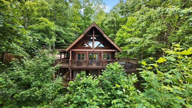 945 Scenic Trl, Gatlinburg, TN 37738 - rear view of house featuring a wooden deck and a view of trees