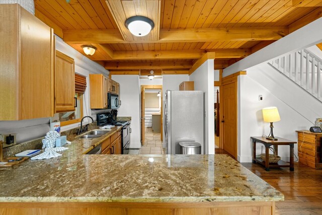945 Scenic Trl, Gatlinburg, TN 37738 - kitchen featuring freestanding refrigerator, range, a wooden ceiling with exposed beams, black microwave, and light stone countertops