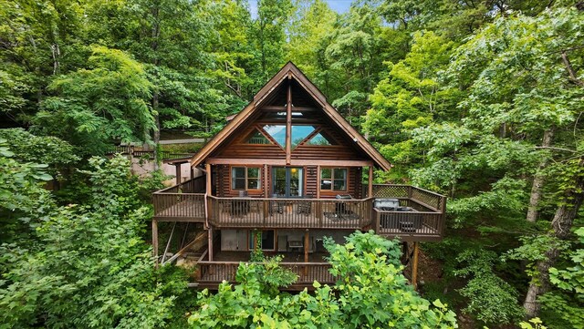 945 Scenic Trl, Gatlinburg, TN 37738 - rear view of house featuring a wooden deck and a forest view
