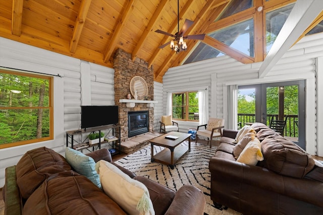 945 Scenic Trl, Gatlinburg, TN 37738 - living room featuring high vaulted ceiling, a ceiling fan, a stone fireplace, a wooden ceiling with exposed beams, and french doors