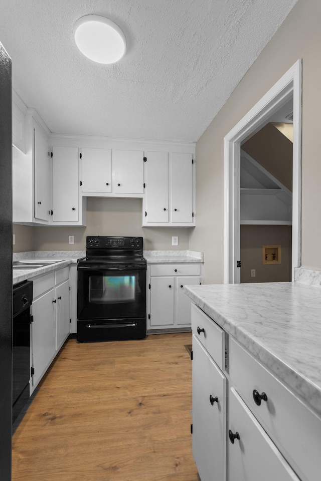 309 Shawnee Dr, Columbia, TN 38401 - kitchen with black appliances, a textured ceiling, white cabinets, light countertops, and light wood finished floors