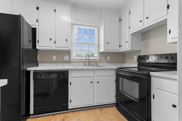 309 Shawnee Dr, Columbia, TN 38401 - kitchen with black appliances, white cabinets, light countertops, and light wood-type flooring