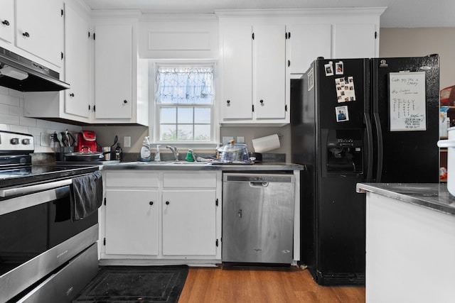 309 Shawnee Dr, Columbia, TN 38401 - kitchen featuring stainless steel appliances, range hood, white cabinetry, and wood finished floors