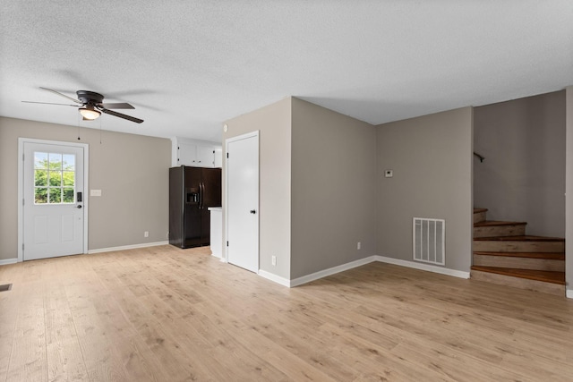 309 Shawnee Dr, Columbia, TN 38401 - unfurnished living room featuring ceiling fan, light wood-style floors, stairway, and a textured ceiling