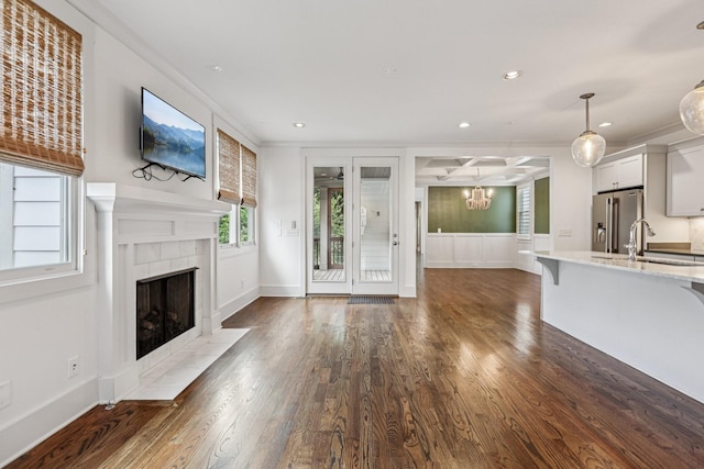 1605 Stokes Ln Unit A, Nashville, TN 37215 - unfurnished living room featuring a tiled fireplace, ornamental molding, dark wood-type flooring, a chandelier, and recessed lighting