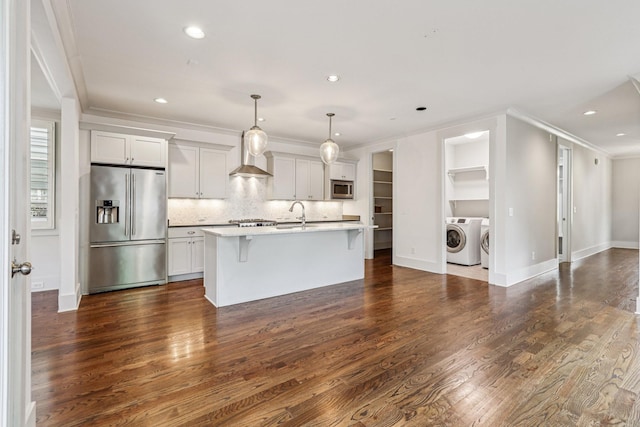 1605 Stokes Ln Unit A, Nashville, TN 37215 - kitchen with stainless steel appliances, washing machine and clothes dryer, ornamental molding, light countertops, and a kitchen breakfast bar