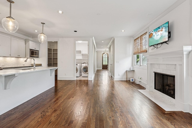 1605 Stokes Ln Unit A, Nashville, TN 37215 - unfurnished living room with independent washer and dryer, dark wood finished floors, ornamental molding, recessed lighting, and a tiled fireplace