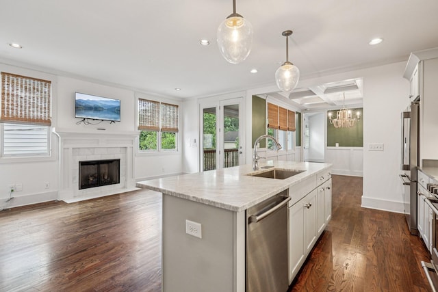 1605 Stokes Ln Unit A, Nashville, TN 37215 - kitchen featuring appliances with stainless steel finishes, a chandelier, a tiled fireplace, dark wood-style floors, and open floor plan
