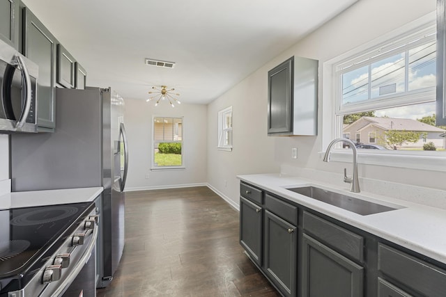 3136 Lauren Evelyn Way, Nashville, TN 37207 - kitchen featuring stainless steel appliances, light countertops, dark wood finished floors, and gray cabinetry
