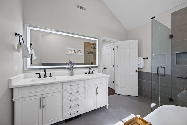 405 Wexford Ct, Franklin, TN 37069 - full bath featuring a stall shower, double vanity, lofted ceiling, tile patterned floors, and a freestanding tub