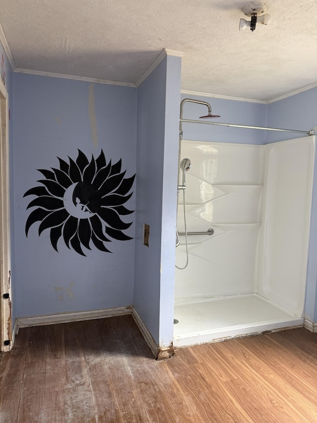 9843 Ed Lyell Rd, Lyles, TN 37098 - full bath with wood finished floors, a textured ceiling, a stall shower, and crown molding