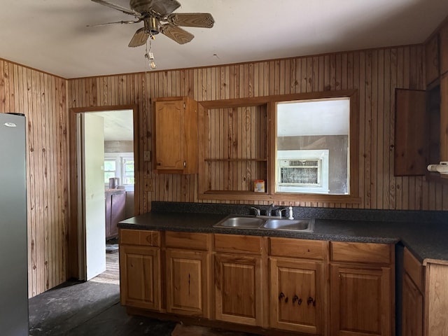 9843 Ed Lyell Rd, Lyles, TN 37098 - kitchen with freestanding refrigerator, wood walls, dark countertops, and ceiling fan