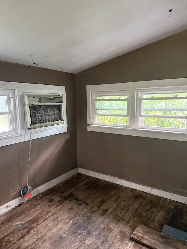 9843 Ed Lyell Rd, Lyles, TN 37098 - empty room with dark wood-type flooring, lofted ceiling, healthy amount of natural light, and a wall unit AC