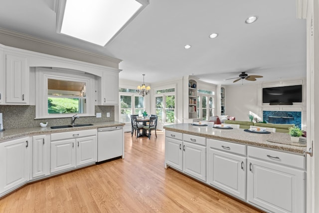 162 N Berwick Ln, Franklin, TN 37069 - kitchen with white dishwasher, white cabinets, recessed lighting, light wood-style flooring, and tasteful backsplash