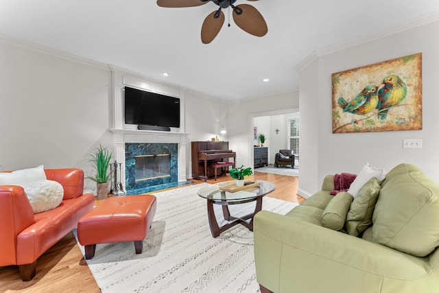 162 N Berwick Ln, Franklin, TN 37069 - living area featuring wood finished floors, ornamental molding, a ceiling fan, recessed lighting, and a premium fireplace
