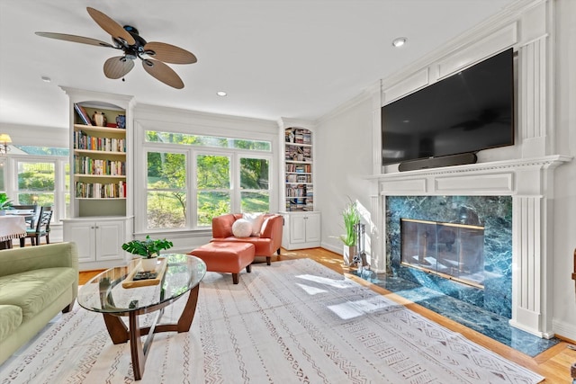 162 N Berwick Ln, Franklin, TN 37069 - living area with a high end fireplace, wood finished floors, built in features, a ceiling fan, and recessed lighting