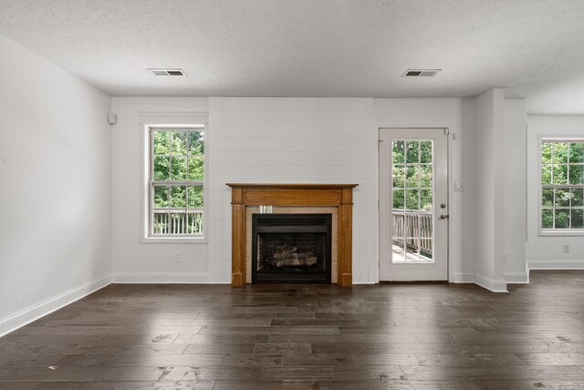 3158 Whitetail Dr, Clarksville, TN 37043 - unfurnished living room with a textured ceiling, dark wood-style floors, and a fireplace