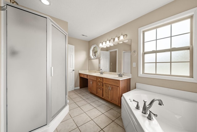3158 Whitetail Dr, Clarksville, TN 37043 - full bathroom with double vanity, a shower stall, a garden tub, and tile patterned flooring