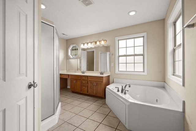 3158 Whitetail Dr, Clarksville, TN 37043 - bathroom with double vanity, a jetted tub, a stall shower, and tile patterned flooring