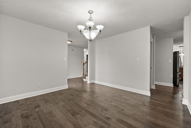 3158 Whitetail Dr, Clarksville, TN 37043 - spare room with a chandelier, dark wood-style floors, a textured ceiling, and stairs