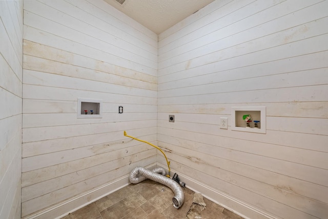 3158 Whitetail Dr, Clarksville, TN 37043 - laundry area featuring electric dryer hookup, wood walls, hookup for a washing machine, and a textured ceiling