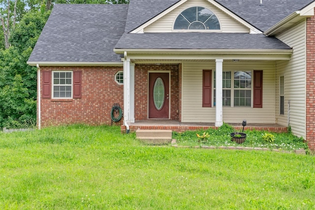 3158 Whitetail Dr, Clarksville, TN 37043 - view of front of house with covered porch, a front lawn, a shingled roof, and brick siding