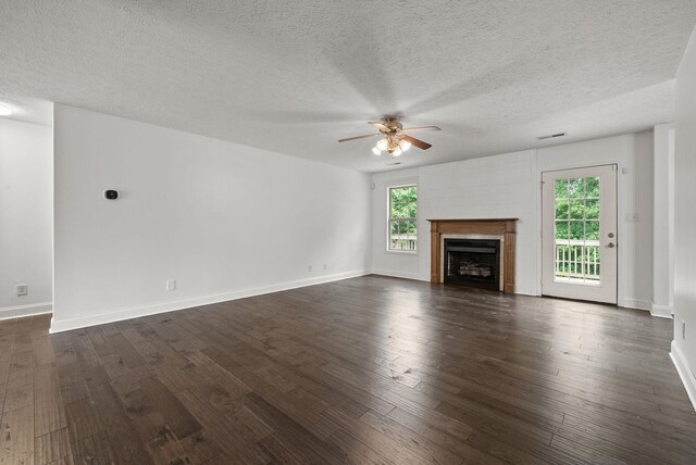 3158 Whitetail Dr, Clarksville, TN 37043 - unfurnished living room with ceiling fan, dark wood-type flooring, a textured ceiling, and a fireplace