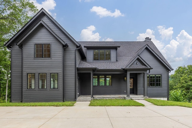 928 Harbor Pointe Dr, Silver Point, TN 38582 - view of front facade featuring covered porch, a shingled roof, and a chimney