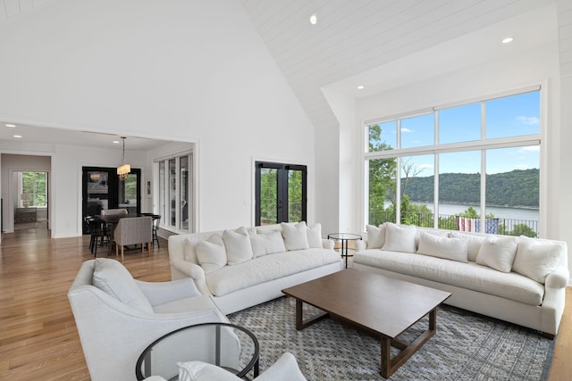 928 Harbor Pointe Dr, Silver Point, TN 38582 - living room with recessed lighting, high vaulted ceiling, light wood finished floors, and a water view