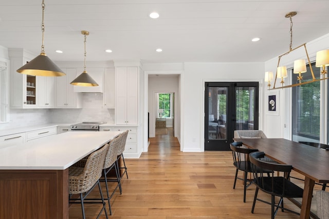 928 Harbor Pointe Dr, Silver Point, TN 38582 - kitchen featuring light countertops, light wood-style floors, recessed lighting, white cabinets, and tasteful backsplash