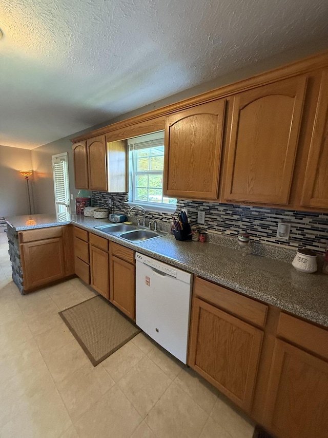 191 Lookout Cir, Trenton, GA 30752 - kitchen with dishwasher, decorative backsplash, a peninsula, brown cabinets, and a textured ceiling