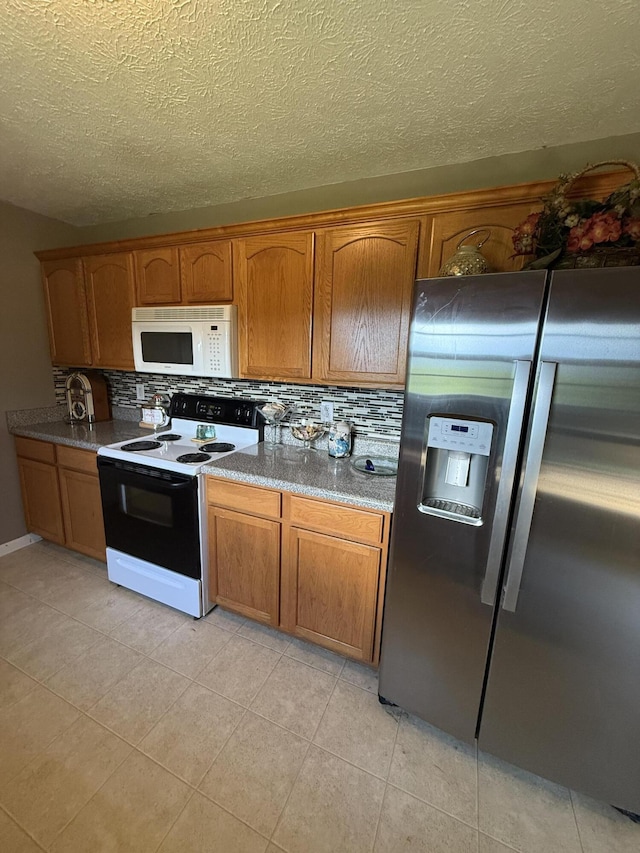 191 Lookout Cir, Trenton, GA 30752 - kitchen with stainless steel fridge, white microwave, range with electric cooktop, decorative backsplash, and a textured ceiling
