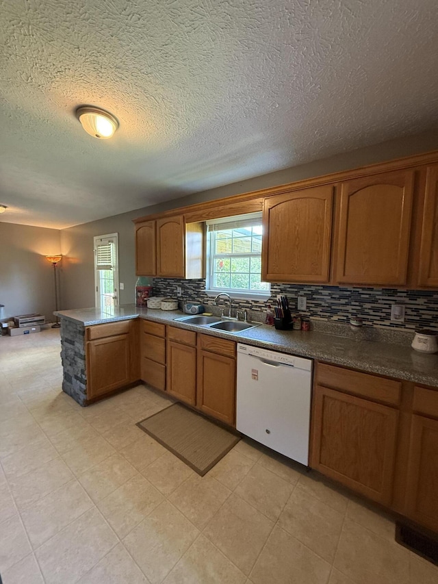 191 Lookout Cir, Trenton, GA 30752 - kitchen featuring white dishwasher, backsplash, healthy amount of natural light, brown cabinetry, and a textured ceiling