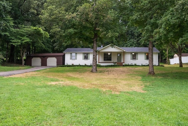 1122 Ridgecrest Dr, Dickson, TN 37055 - ranch-style house with covered porch, driveway, a front lawn, an outbuilding, and an attached garage
