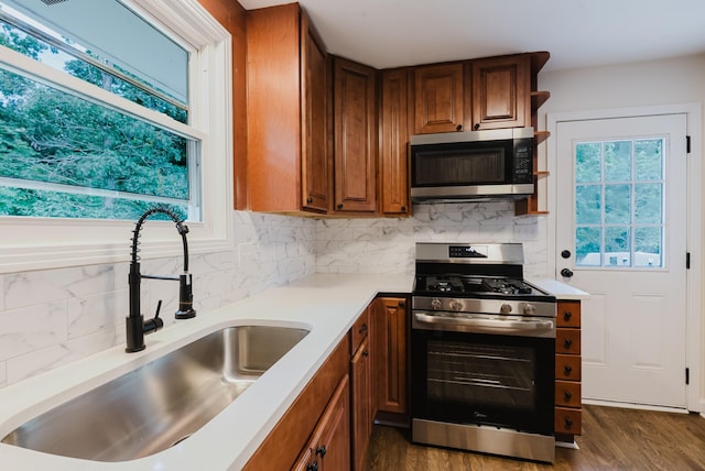 143 Bishop Ln, Burns, TN 37029 - kitchen featuring stainless steel appliances, backsplash, light countertops, dark wood finished floors, and brown cabinetry