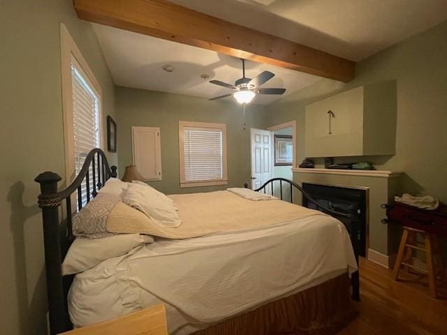 25 Bradley Ln, Bath Springs, TN 38311 - bedroom featuring wood finished floors, a fireplace, beamed ceiling, and ceiling fan