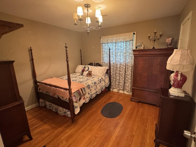 123 Coffman Dr, Fort Oglethorpe, GA 30742 - bedroom featuring light wood-style floors and a chandelier