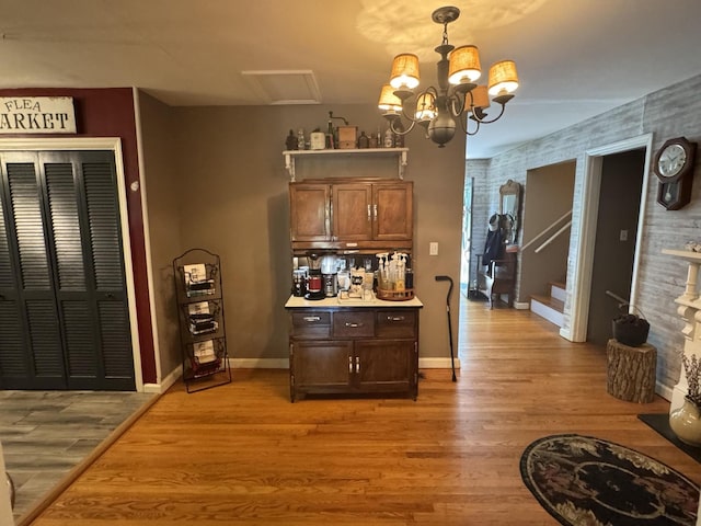 123 Coffman Dr, Fort Oglethorpe, GA 30742 - bar featuring light wood-type flooring, a chandelier, and decorative light fixtures