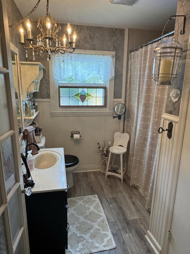 123 Coffman Dr, Fort Oglethorpe, GA 30742 - full bathroom with wood finished floors, vanity, a chandelier, a shower with shower curtain, and wainscoting