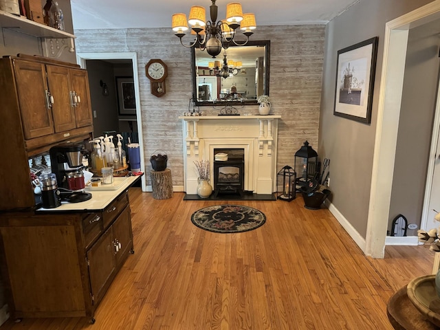 123 Coffman Dr, Fort Oglethorpe, GA 30742 - living room with a chandelier, an accent wall, wood finished floors, and a fireplace with flush hearth