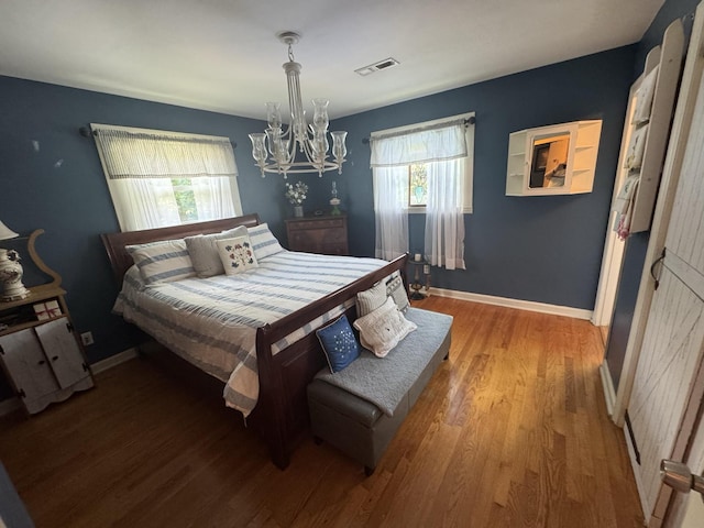 123 Coffman Dr, Fort Oglethorpe, GA 30742 - bedroom with multiple windows, a chandelier, and wood finished floors