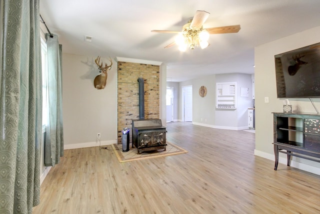 3150 Sugar Creek Rd, Woodlawn, TN 37191 - unfurnished living room with a wood stove, wood finished floors, and ceiling fan
