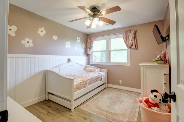 3150 Sugar Creek Rd, Woodlawn, TN 37191 - bedroom with light wood finished floors, wainscoting, and a ceiling fan