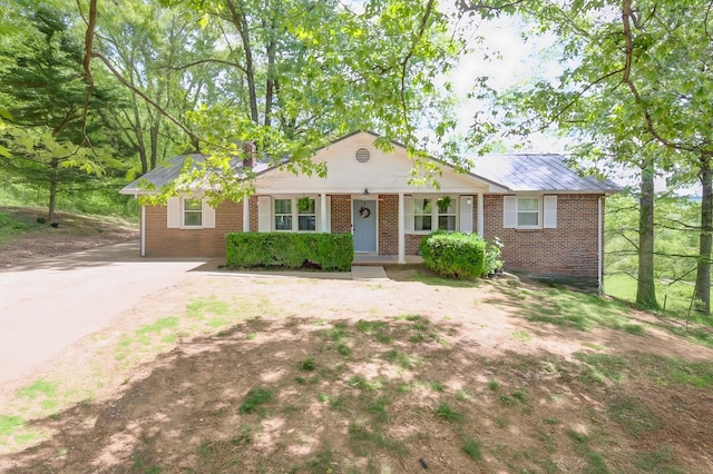 3150 Sugar Creek Rd, Woodlawn, TN 37191 - ranch-style home with brick siding, a porch, and concrete driveway