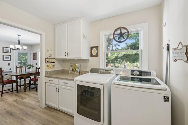 1201 Natchez Rd, Franklin, TN 37069 - laundry area with cabinet space, washing machine and dryer, healthy amount of natural light, and a chandelier