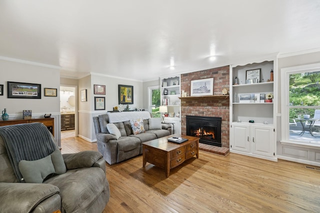 1201 Natchez Rd, Franklin, TN 37069 - living room with light wood-style floors, a brick fireplace, crown molding, and built in shelves