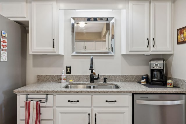 1201 Natchez Rd, Franklin, TN 37069 - kitchen with appliances with stainless steel finishes, white cabinetry, and light stone countertops