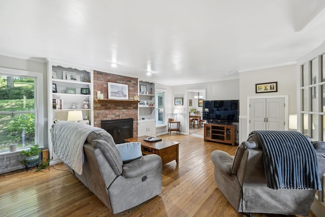 1201 Natchez Rd, Franklin, TN 37069 - living area with wood finished floors, a fireplace, crown molding, and built in shelves